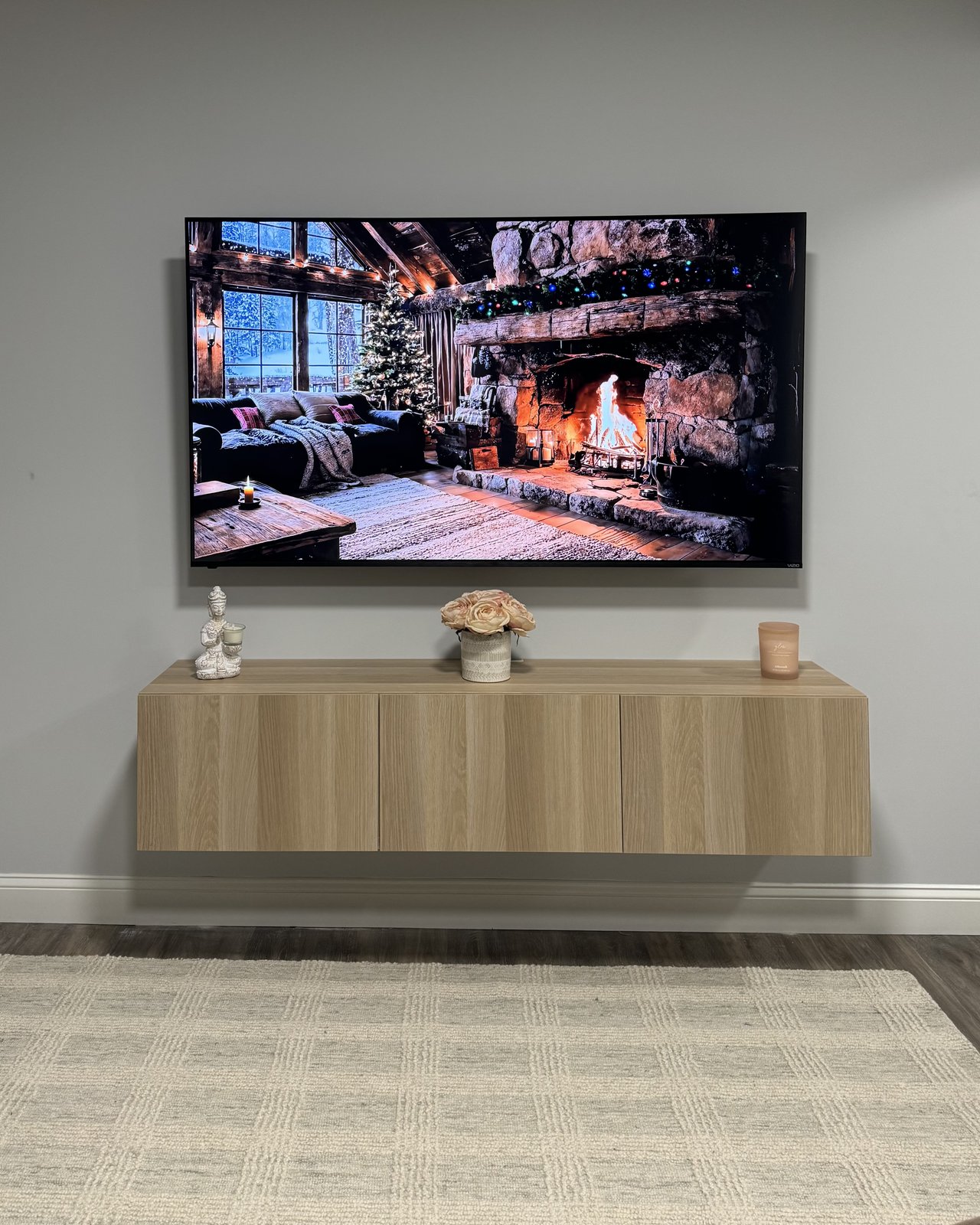 Clean Console Mount: TV mounted clean over a styled white-oak console, by SEIN ME