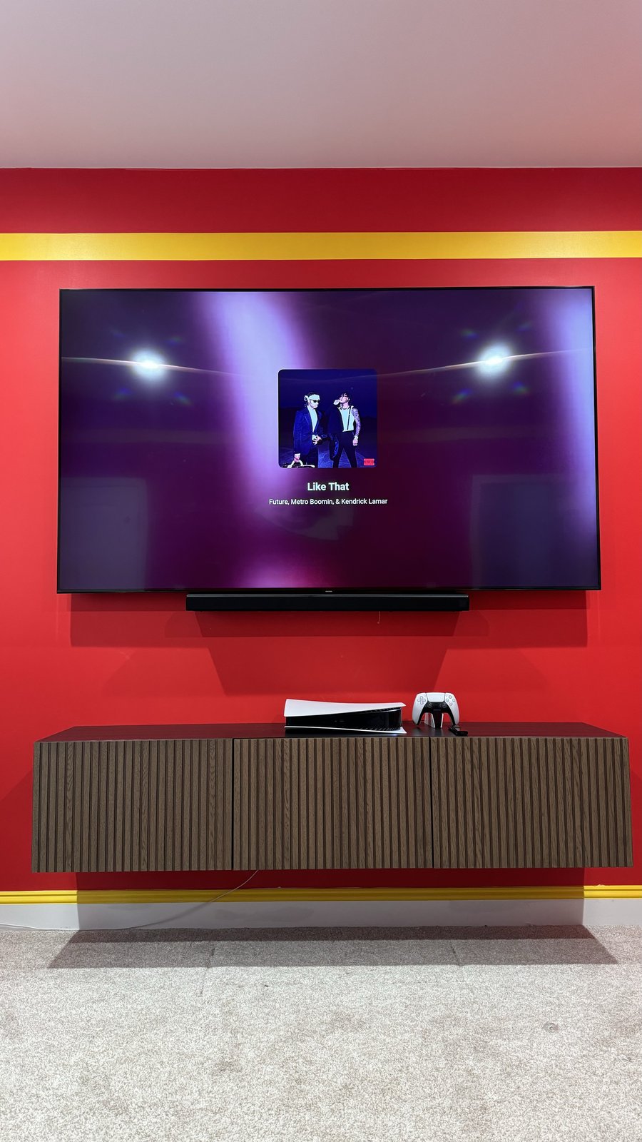 85-inch TV with soundbar and walnut fluted floating console on the red and gold wall, straight on, by SEIN ME in Old Bridge, New Jersey