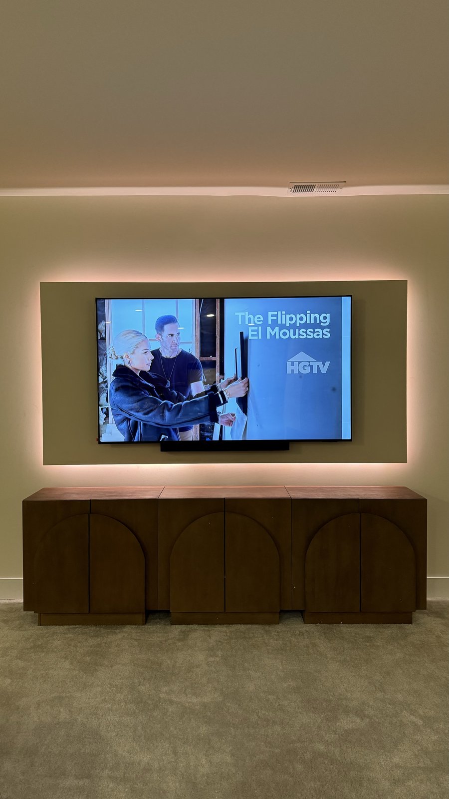 Olive-taupe backer panel with warm LED halo and walnut sideboard by SEIN ME in Union, New Jersey