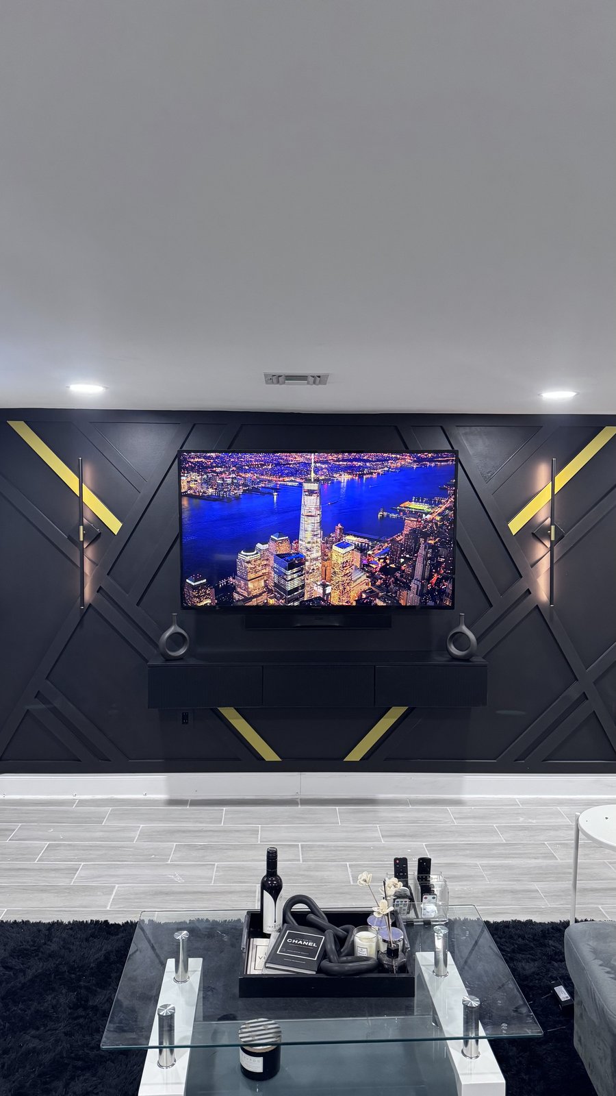 Custom geometric accent wall in black and gold with mounted TV, installed by SEIN ME in Union, New Jersey