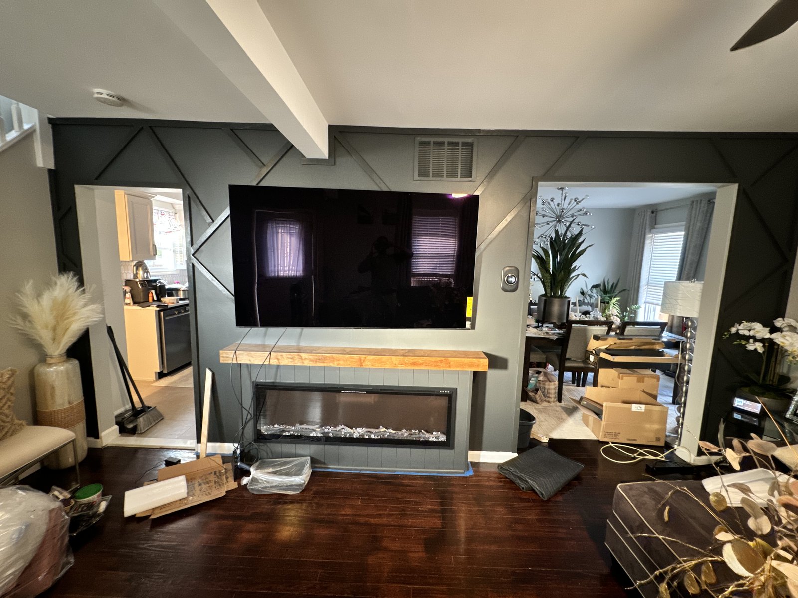 Media wall mid-install with cables and materials staged in a Plainfield, New Jersey living room, by SEIN ME