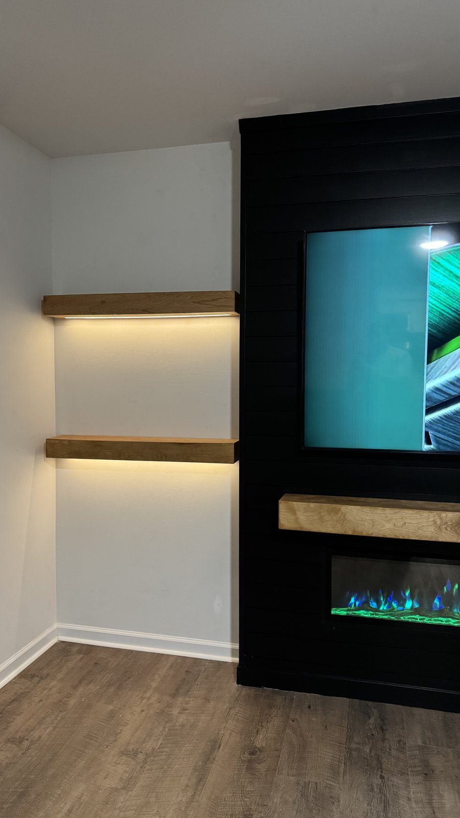 The LED Mantel by SEIN ME, integrated lighting over a lit fireplace
