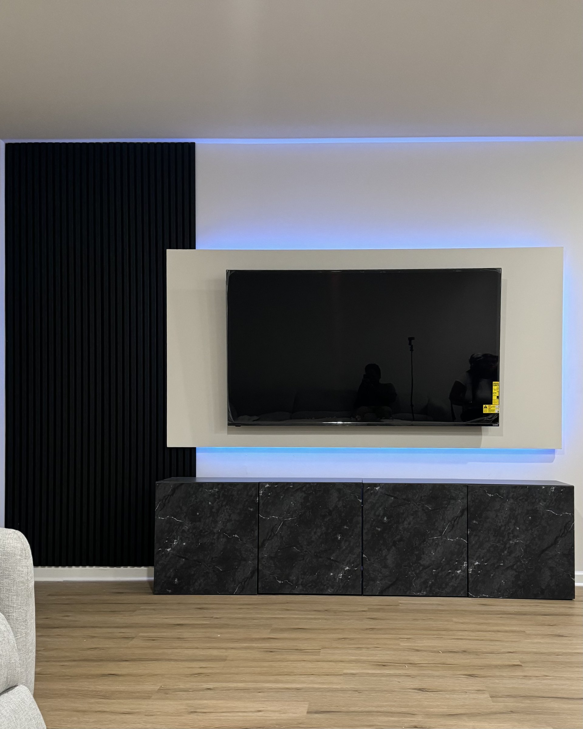 The Glendora floating panel media wall with the TV off, showing panel proportions and glow, by SEIN ME