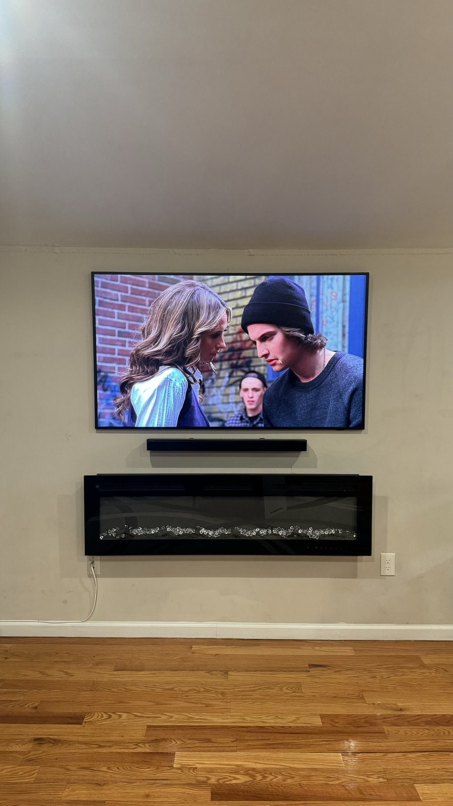 Mounted TV with soundbar shelf and linear fireplace stack by SEIN ME in Morristown, New Jersey