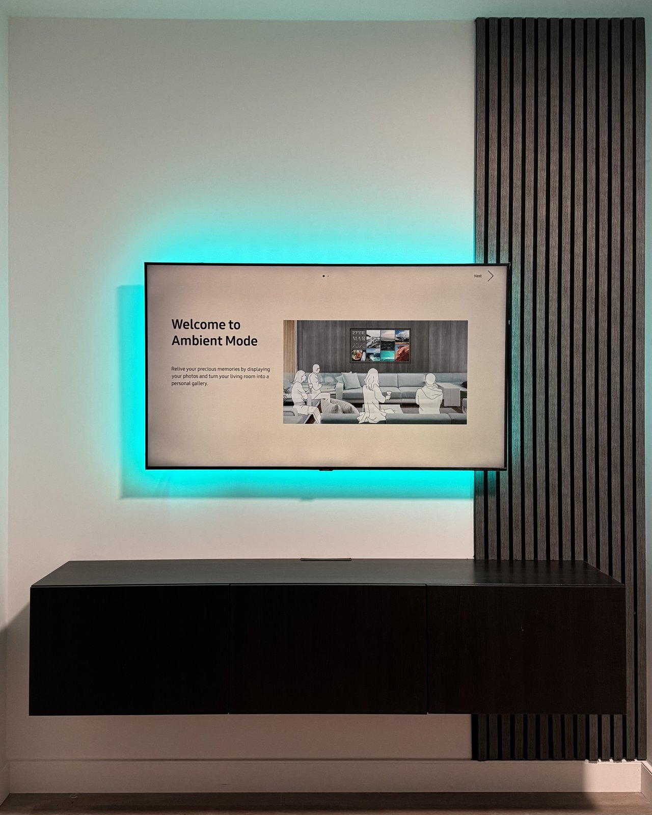 Floating panel with teal LED halo, gray oak slat column and espresso console by SEIN ME in Morristown, New Jersey