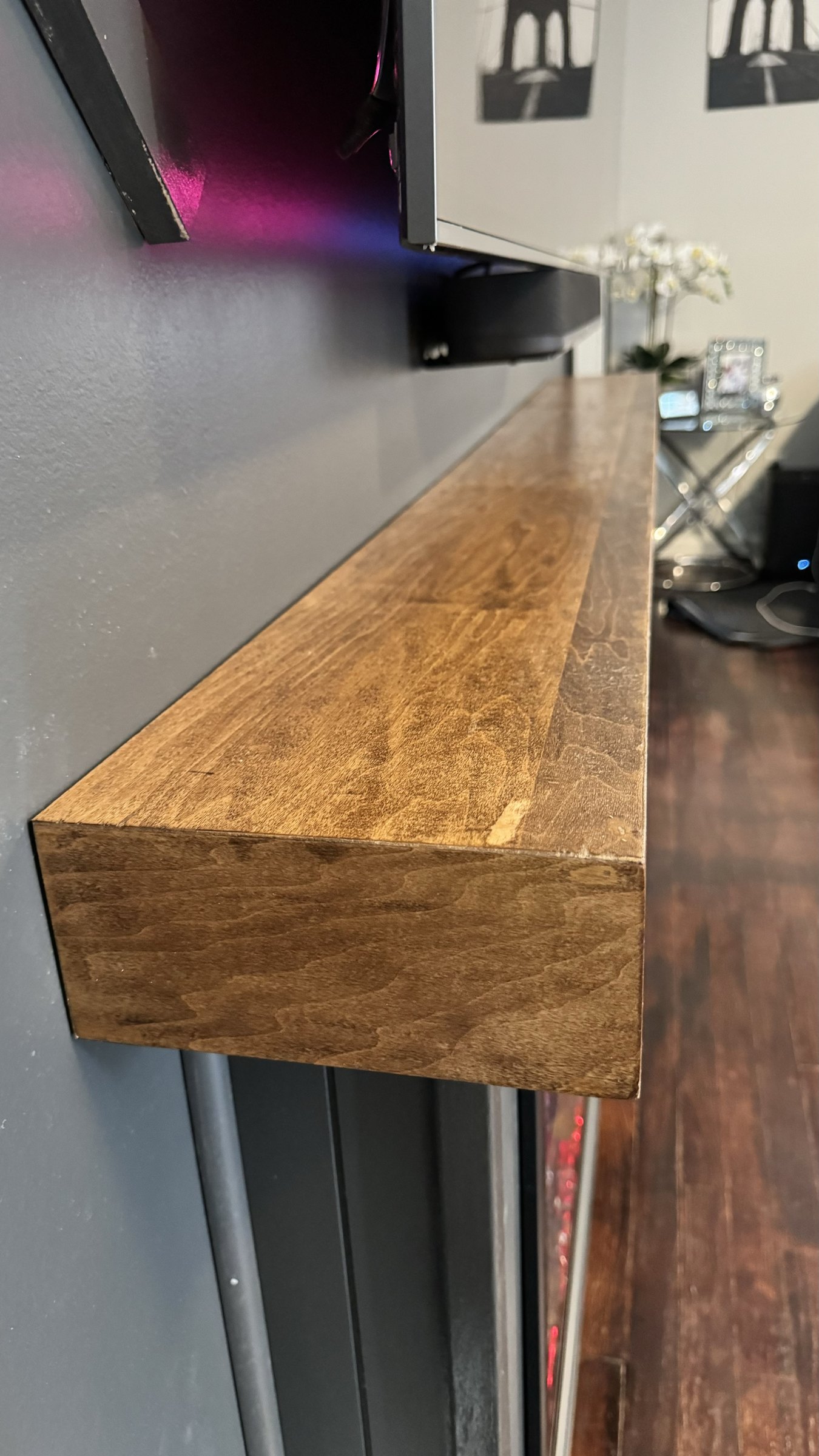 Close detail of the wood grain on a dark stained SEIN ME floating mantel