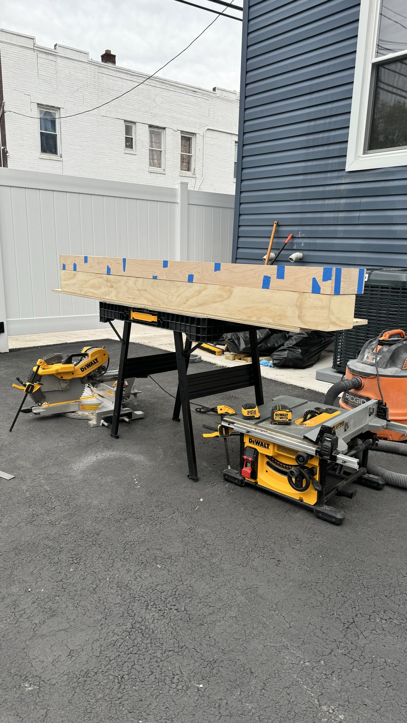 Raw oak mantel box being cut and assembled on sawhorses in the SEIN ME workshop