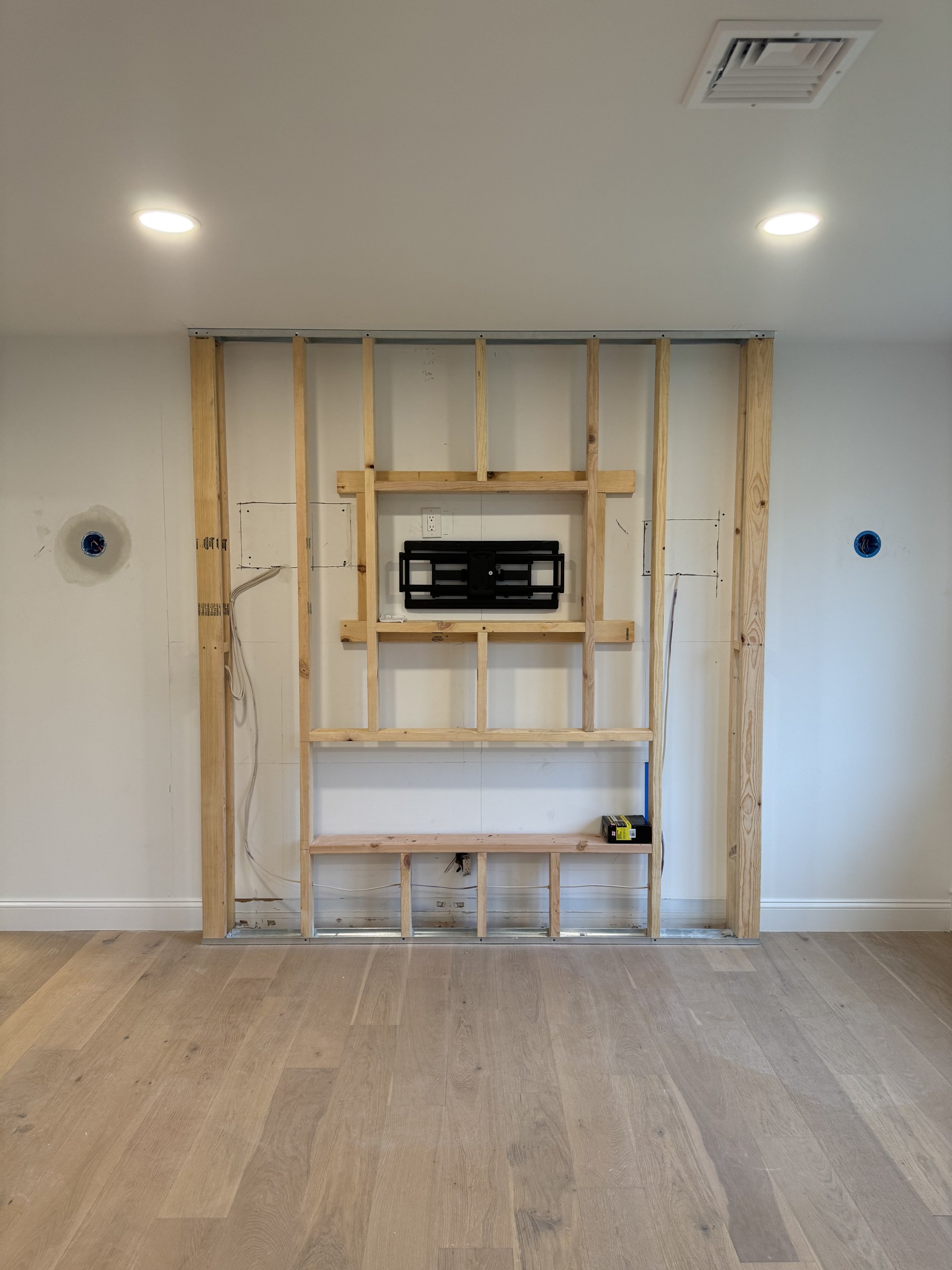 Media wall framing with blocking, TV mount and roughed-in wiring by SEIN ME in Piscataway, New Jersey