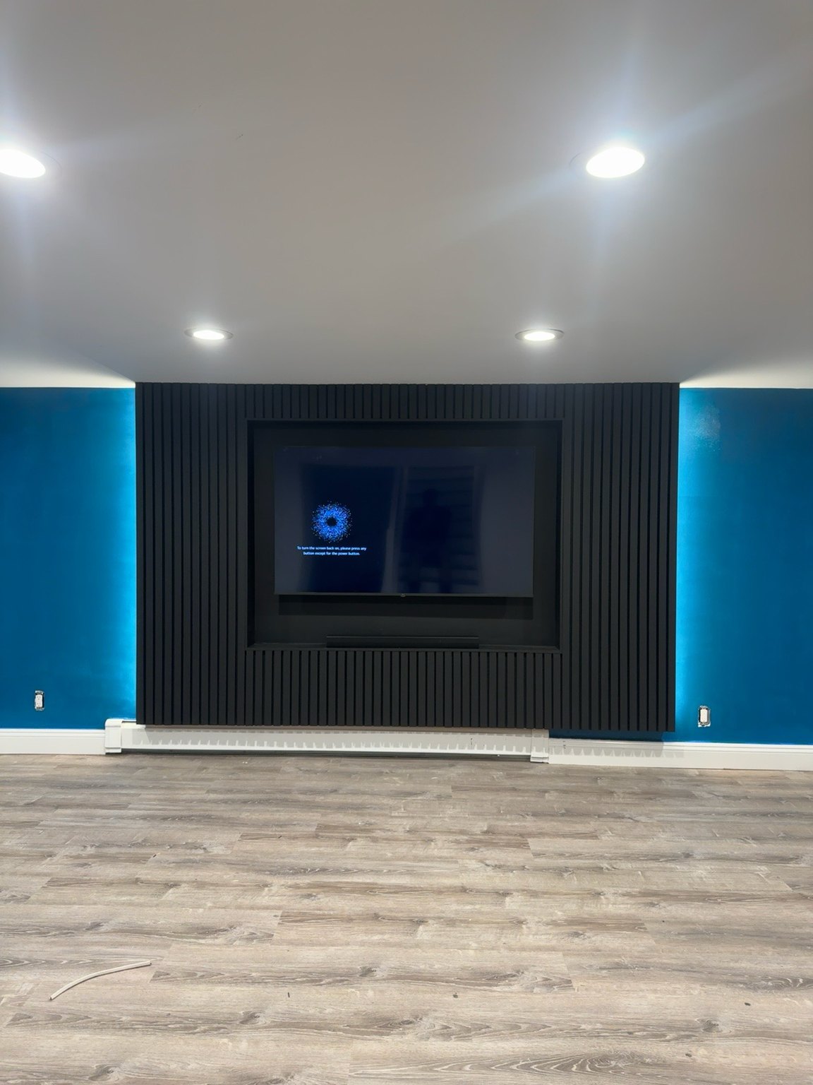 The same black slat niche wall after the client painted the room blue, by SEIN ME in Piscataway, New Jersey