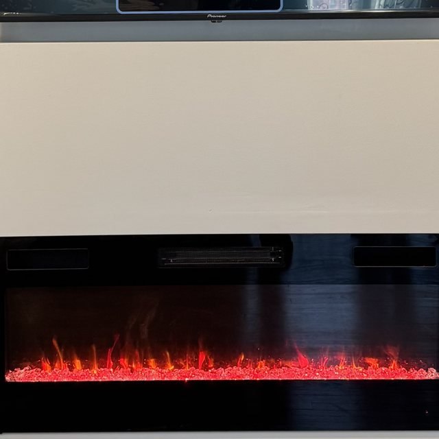 Linear fireplace flames up close under a floating TV